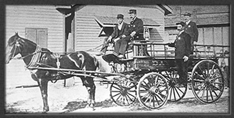 four men on a horse-drawn wagon in 1800's