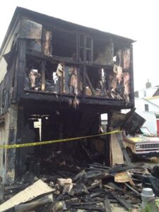 Burnt front of an apartment building after a fire that started below in a garage