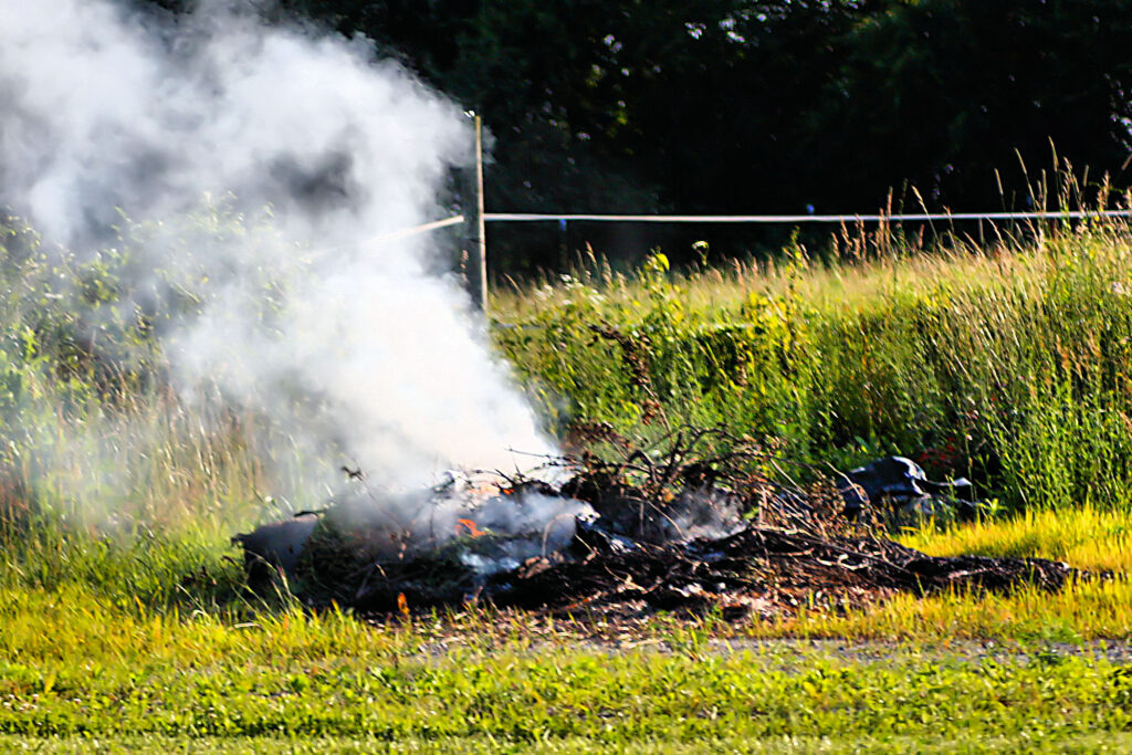 small fire burning leaves and brush
